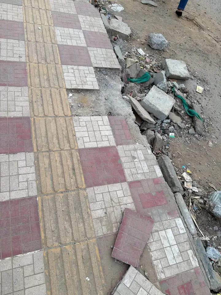 broken sidewalk in Institutional Area